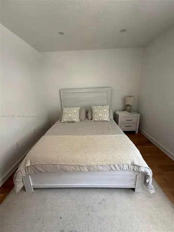 a bedroom with a bed and a lamp