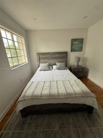 a bed sitting in a bedroom next to a window