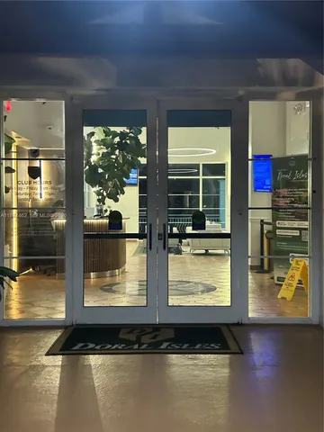 a dining room with furniture and a floor to ceiling window