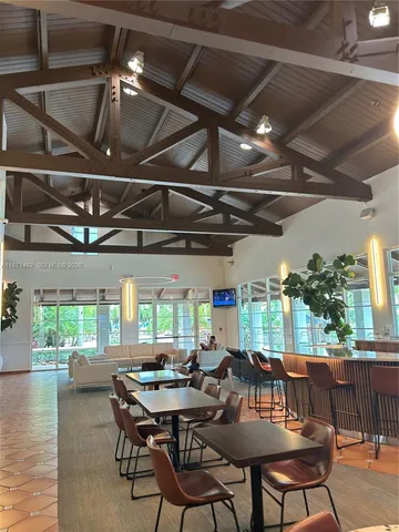 a living room with furniture floor to ceiling window and floor to ceiling window