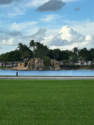 a view of outdoor space with swimming pool and trees in the background