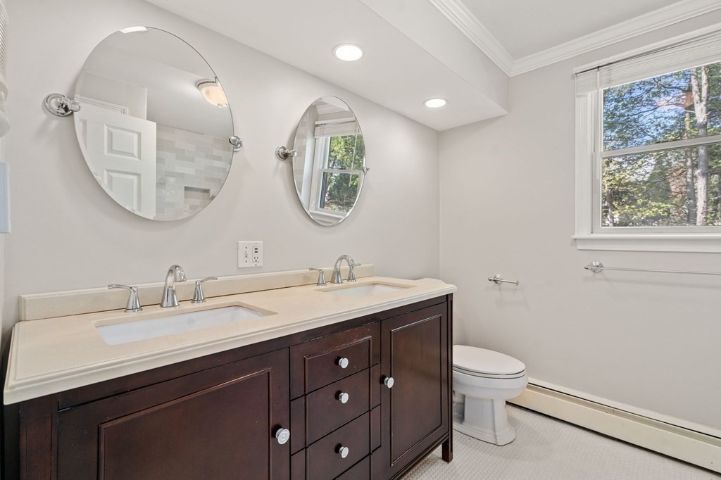 59 Standish Road Wellesley, MA 02481 - Photo 17 of 31 a bathroom with a toilet a double vanity sink and a mirror