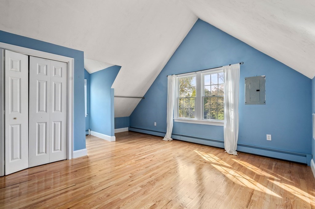 59 Standish Road Wellesley, MA 02481 - Photo 18 of 31 a view of an empty room with a window and wooden floor