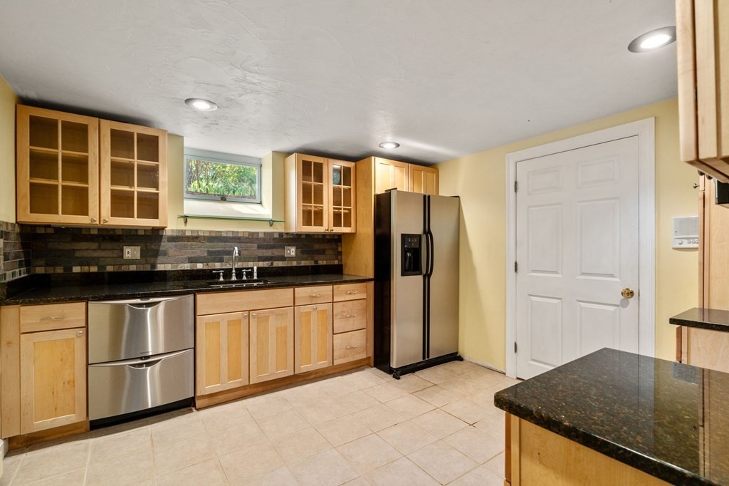59 Standish Road Wellesley, MA 02481 - Photo 23 of 31 a kitchen with granite countertop a stove a sink and a refrigerator