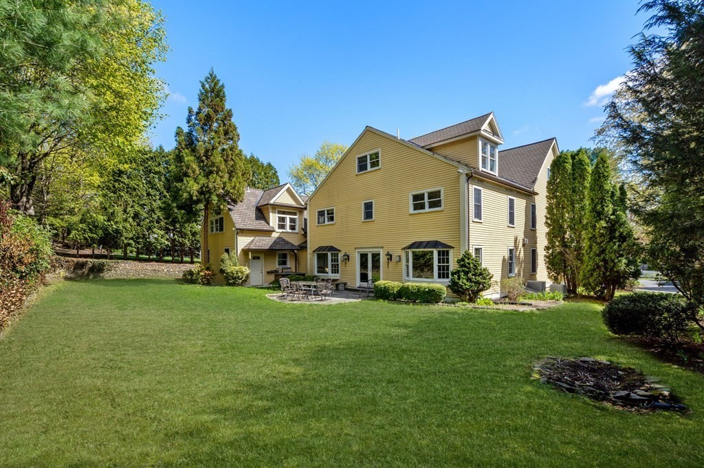 59 Standish Road Wellesley, MA 02481 - Photo 28 of 31 a view of a white house with a big yard and large trees