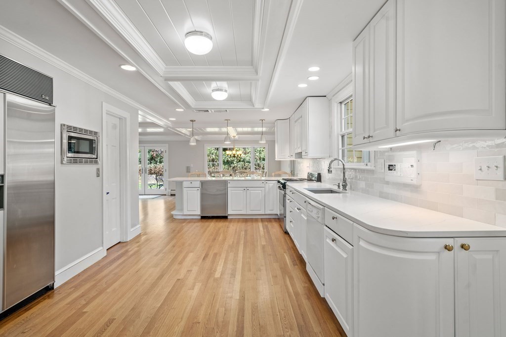 59 Standish Road Wellesley, MA 02481 - Photo 6 of 31 a large kitchen with stainless steel appliances kitchen island a large counter top and a refrigerator