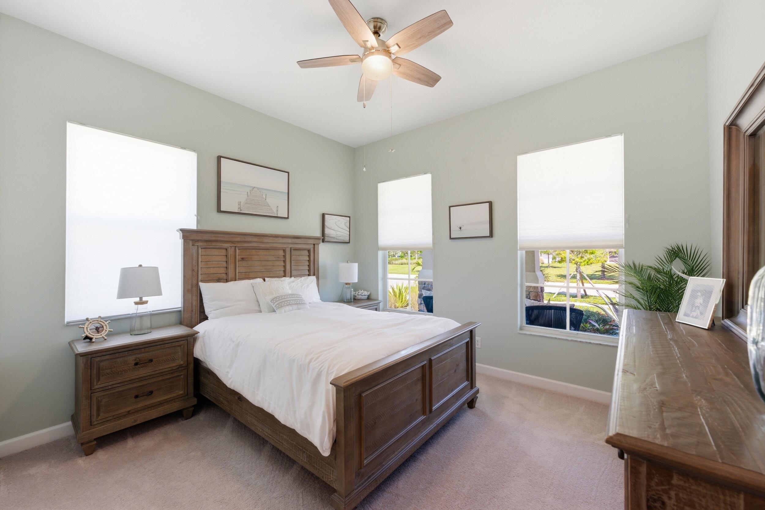 19230 Rolling Acres Road Loxahatchee, FL 33470 - Photo 20 of 58 a bedroom with a bed and a window