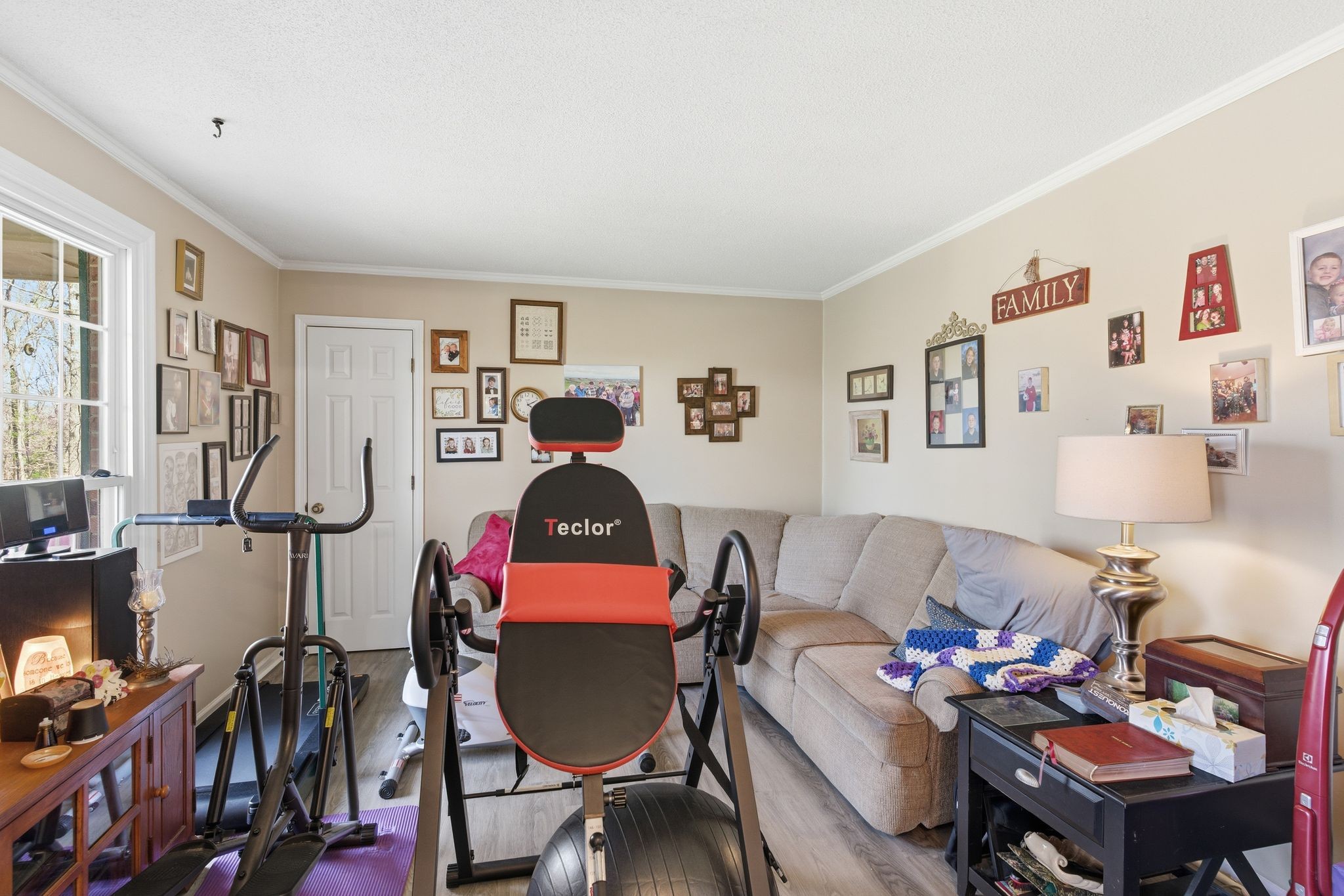 8073 Ridgewood Road Goodlettsville, TN 37072 - Photo 12 of 38 a living room with furniture a rug and gym equipment