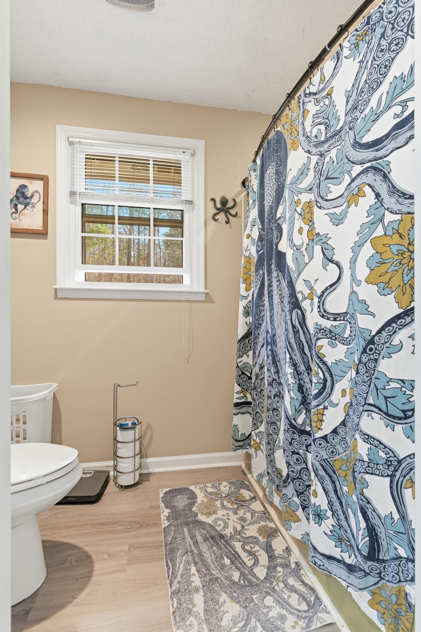 8073 Ridgewood Road Goodlettsville, TN 37072 - Photo 16 of 38 a bathroom with a toilet and a shower curtain