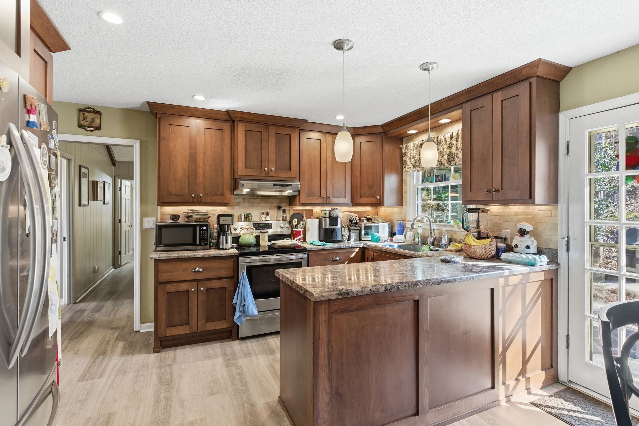 8073 Ridgewood Road Goodlettsville, TN 37072 - Photo 8 of 38 a kitchen with stainless steel appliances granite countertop a refrigerator a sink dishwasher a stove and white countertops with wooden floor