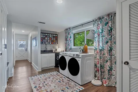 a living room with furniture a flat screen tv and a large window