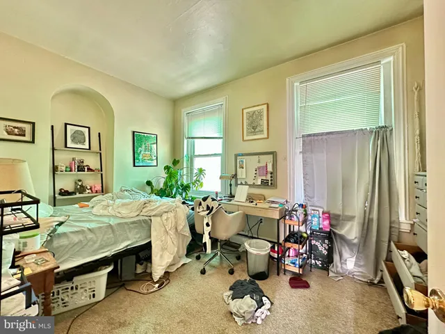 a bed room with furniture and a window