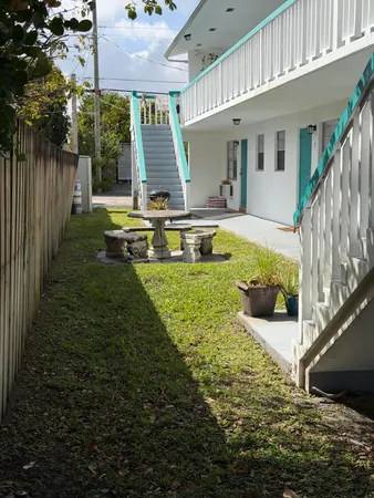 a view of a house with backyard and sitting area