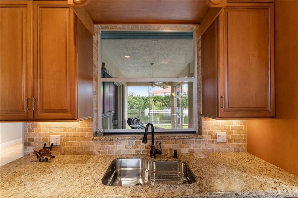 103 Aqua Ra Drive Jensen Beach, FL 34957 - Photo 11 of 48 a kitchen with sink and large window