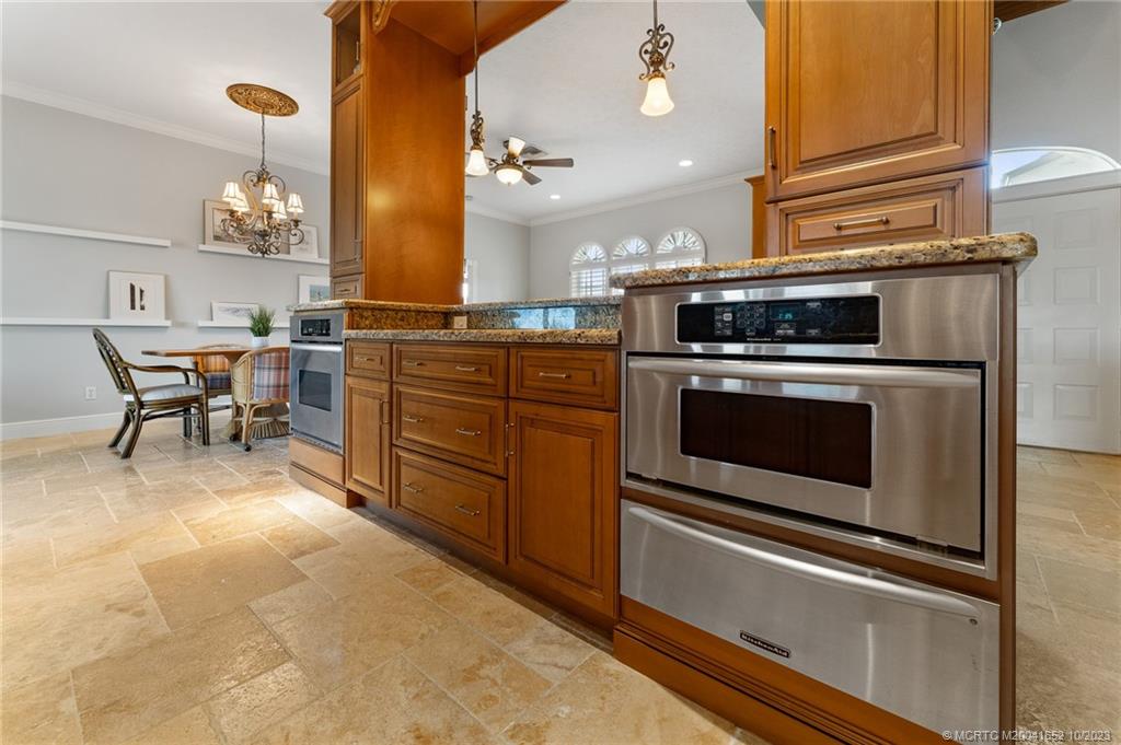 103 Aqua Ra Drive Jensen Beach, FL 34957 - Photo 13 of 48 a kitchen with a stove oven and cabinets