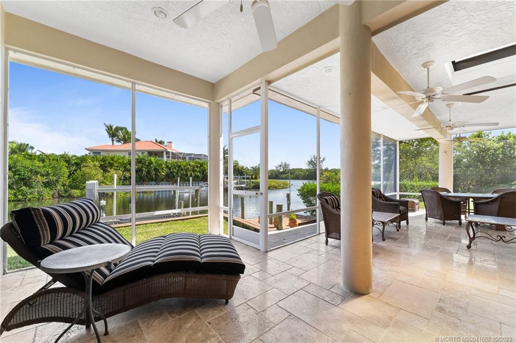 103 Aqua Ra Drive Jensen Beach, FL 34957 - Photo 17 of 48 a living room with furniture and a floor to ceiling window