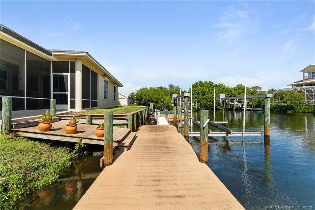 103 Aqua Ra Drive Jensen Beach, FL 34957 - Photo 22 of 48 swimming pool view with a lake view