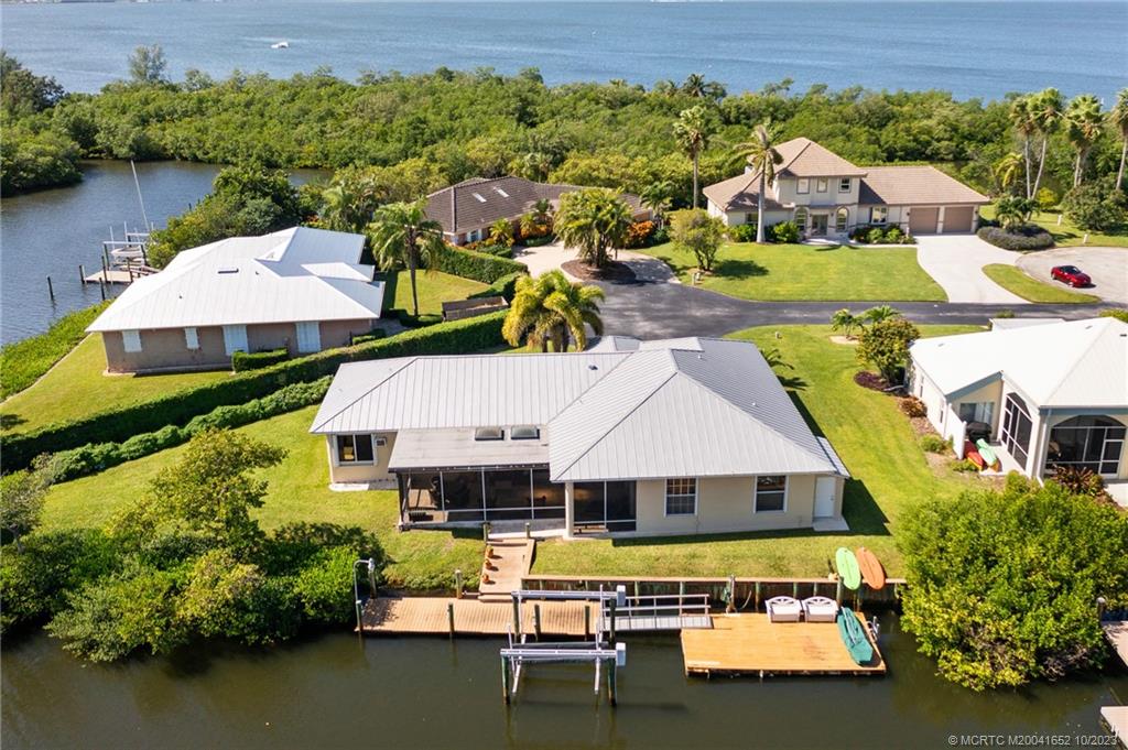103 Aqua Ra Drive Jensen Beach, FL 34957 - Photo 23 of 48 an aerial view of a house with swimming pool and outdoor seating