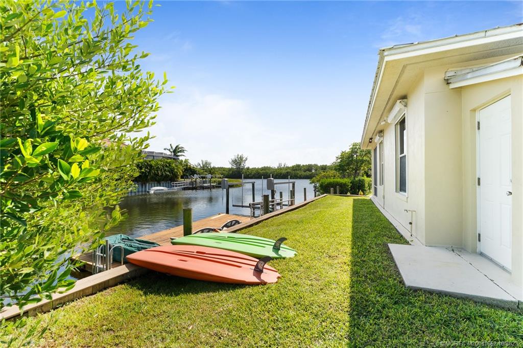 103 Aqua Ra Drive Jensen Beach, FL 34957 - Photo 24 of 48 a view of a lake with couches chairs