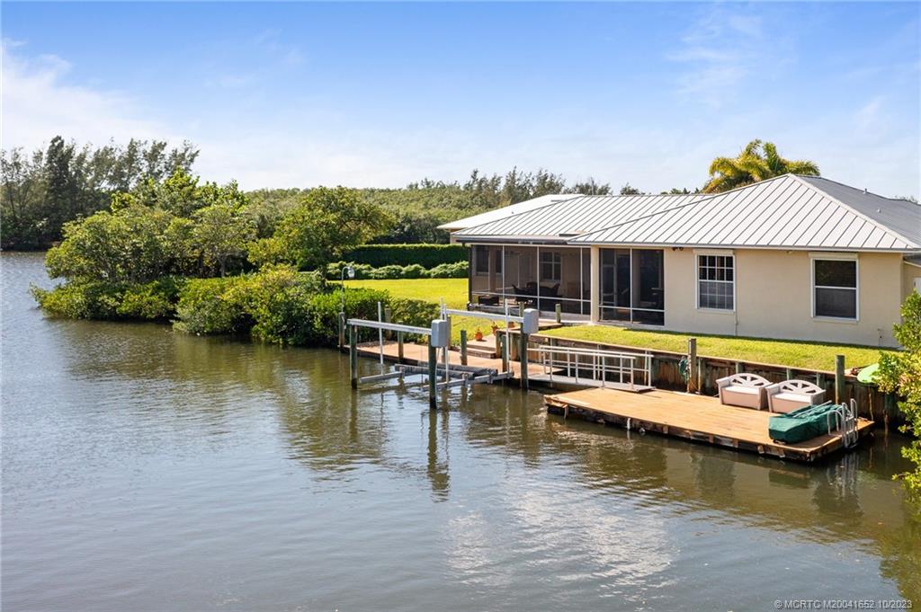 103 Aqua Ra Drive Jensen Beach, FL 34957 - Photo 25 of 48 a aerial view of a house with swimming pool and lake view