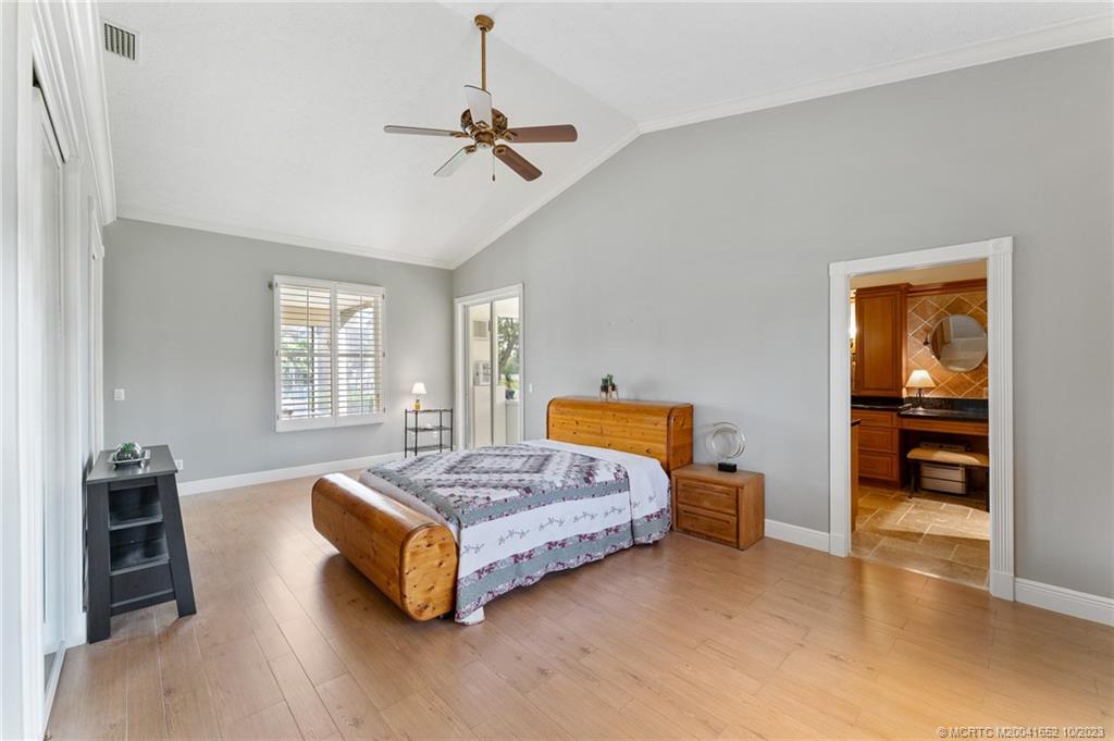 103 Aqua Ra Drive Jensen Beach, FL 34957 - Photo 27 of 48 a bedroom with bed and window