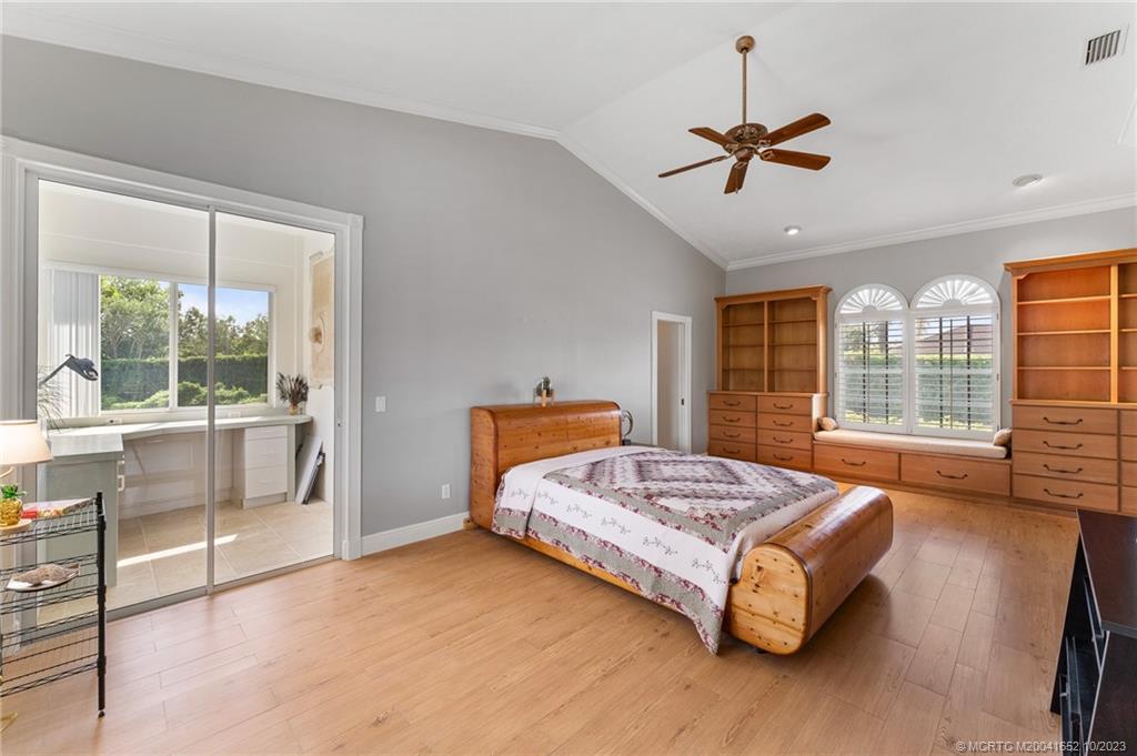 103 Aqua Ra Drive Jensen Beach, FL 34957 - Photo 28 of 48 a bedroom with a bed and large window with outer view