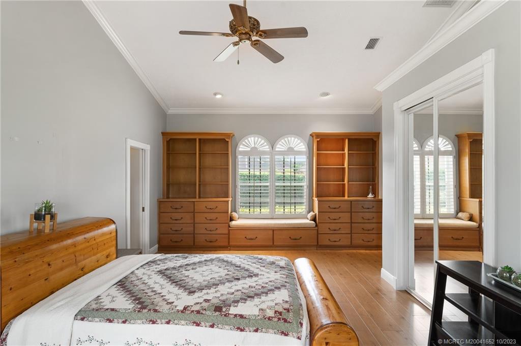 103 Aqua Ra Drive Jensen Beach, FL 34957 - Photo 29 of 48 a bedroom with a bed and wooden floor