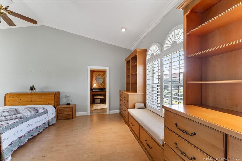 103 Aqua Ra Drive Jensen Beach, FL 34957 - Photo 30 of 48 a bedroom with furniture and a window