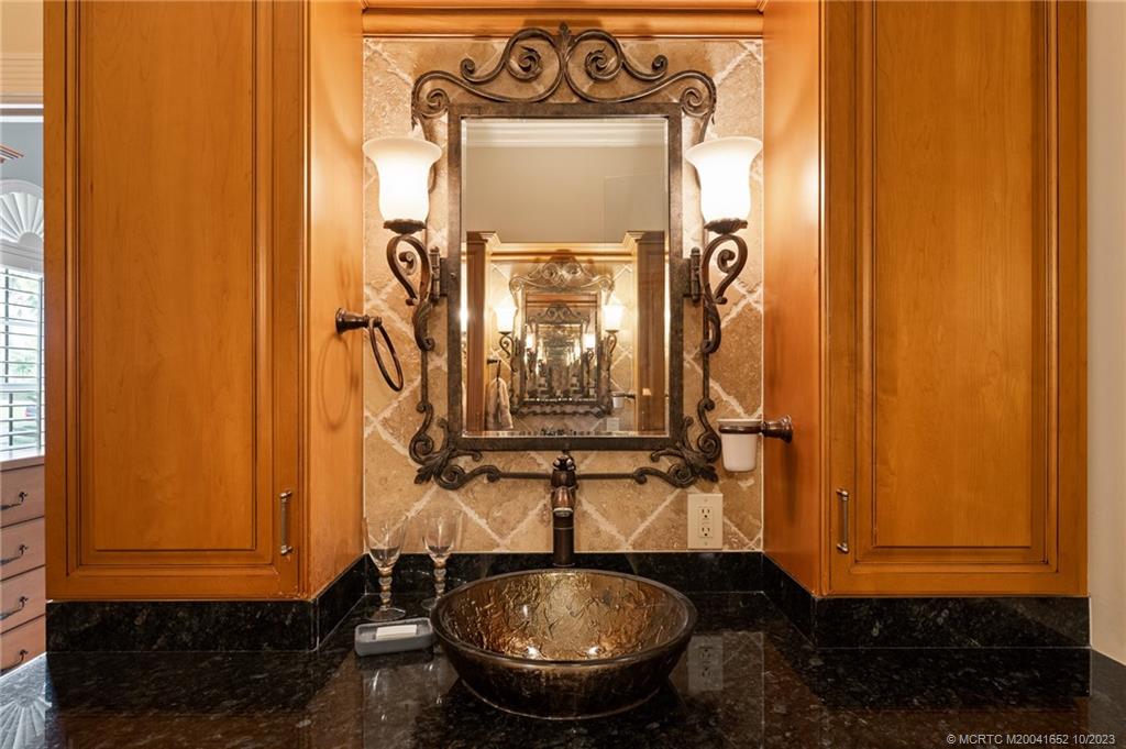 103 Aqua Ra Drive Jensen Beach, FL 34957 - Photo 34 of 48 a bathroom with a sink and a mirror