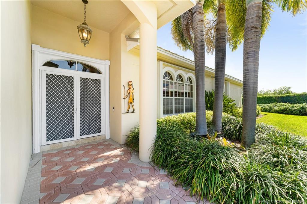 103 Aqua Ra Drive Jensen Beach, FL 34957 - Photo 4 of 48 a view of a front door and porch