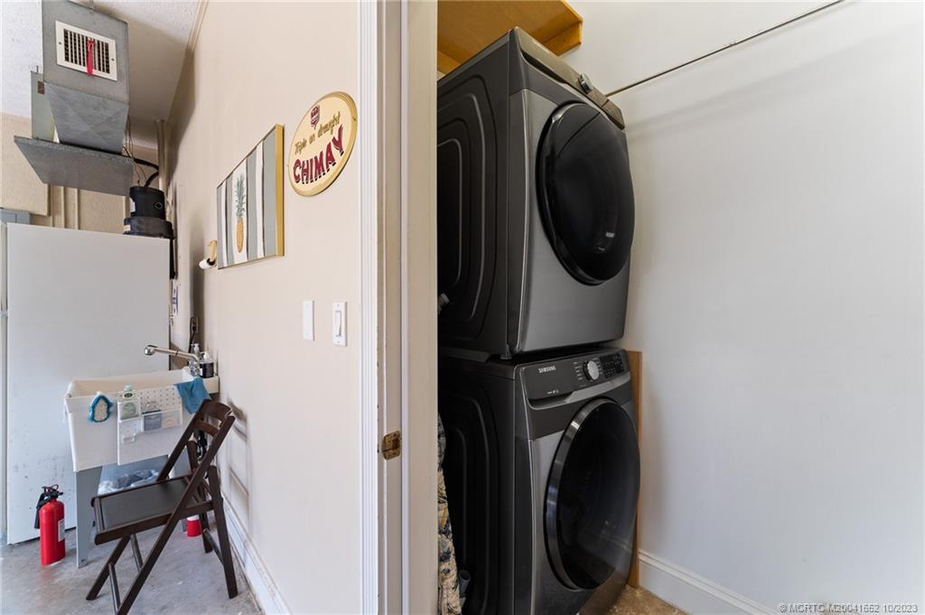 103 Aqua Ra Drive Jensen Beach, FL 34957 - Photo 41 of 48 a utility room with dryer and washer