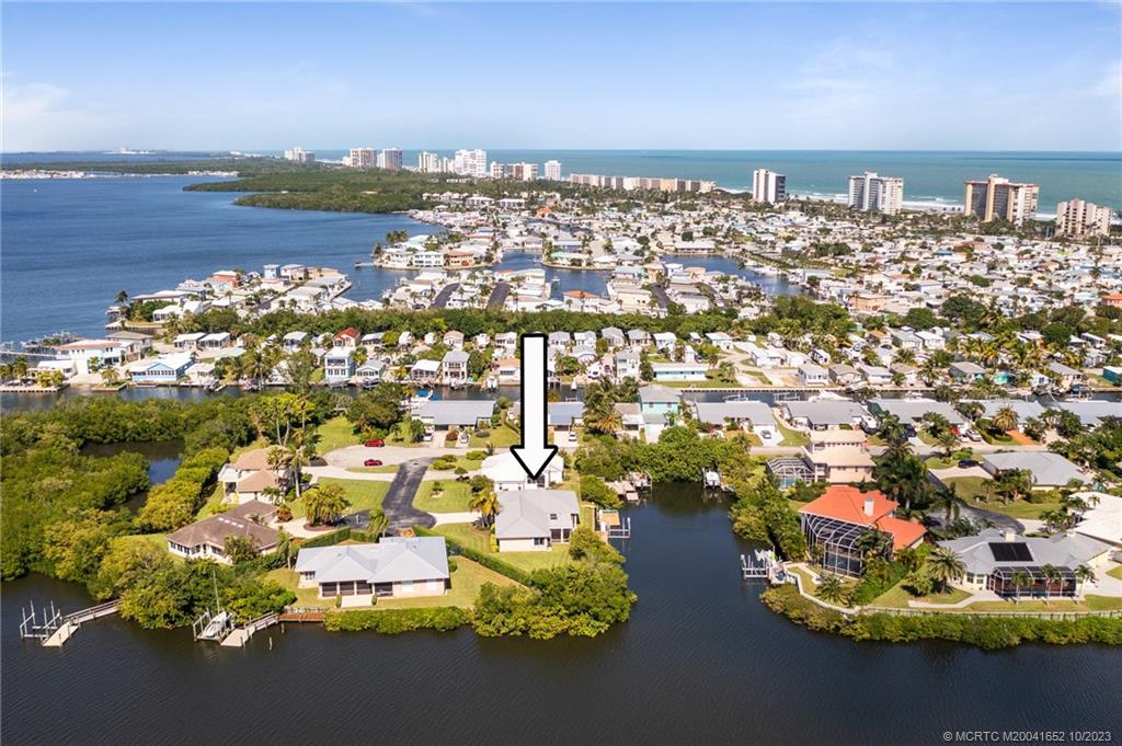 103 Aqua Ra Drive Jensen Beach, FL 34957 - Photo 43 of 48 an aerial view of a city with lots of residential buildings ocean and mountain view in back