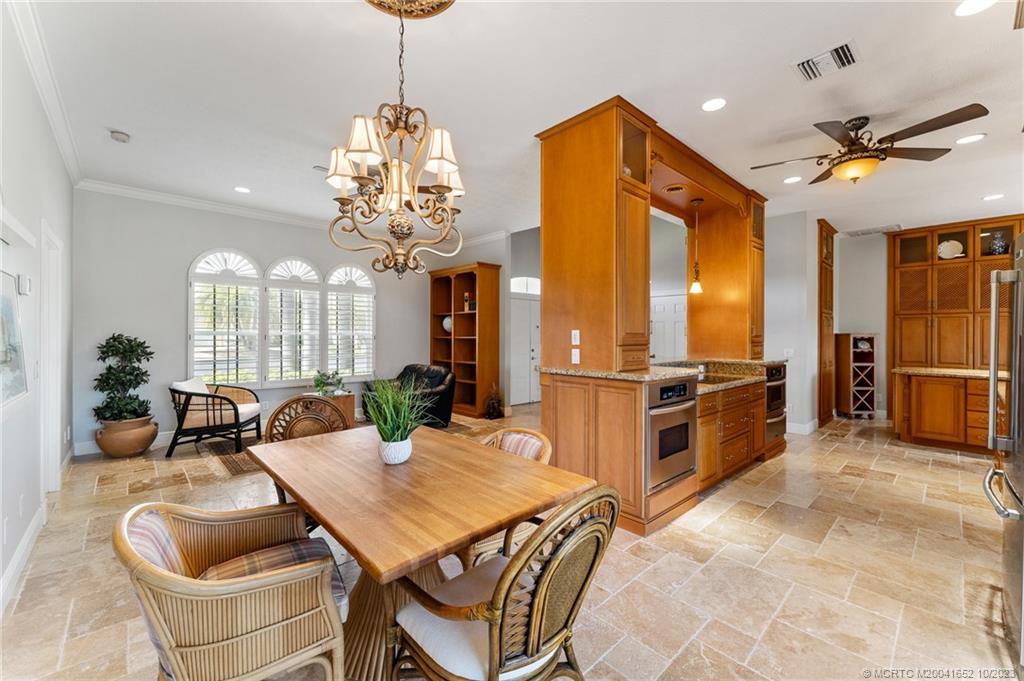 103 Aqua Ra Drive Jensen Beach, FL 34957 - Photo 10 of 48 a view of a dining room furniture and chandelier
