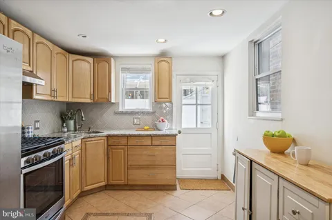 a kitchen with a sink stove and cabinets
