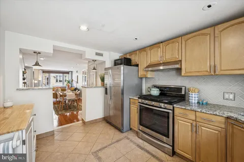 a kitchen with a stove a refrigerator and a sink