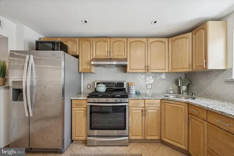 a kitchen with a stove a sink and a refrigerator