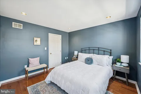 a bedroom with a bed and a lamp