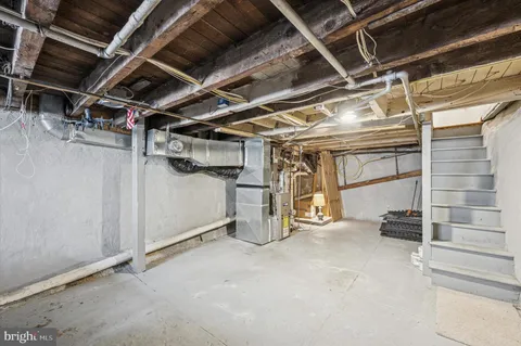 a view of storage and utility room with stairs