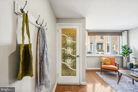 a living room with a couch and wooden floor