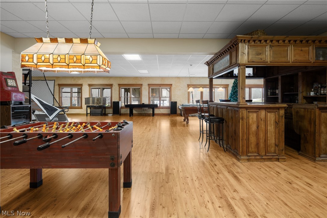 9419 Robinson Road Chardon, OH 44024 - Photo 9 of 46 Game room with a paneled ceiling, billiards table, light wood-style floors, and a bar