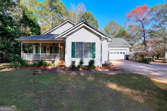 a view of a house with backyard sitting area and garden