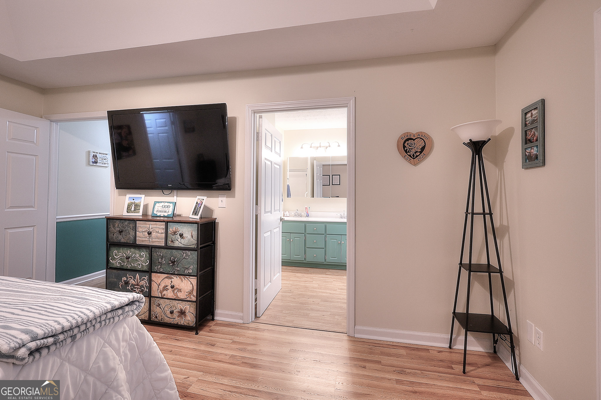 245 Tamea Trail Covington, GA 30014 - Photo 13 of 31 a bedroom with a bed and a flat screen tv