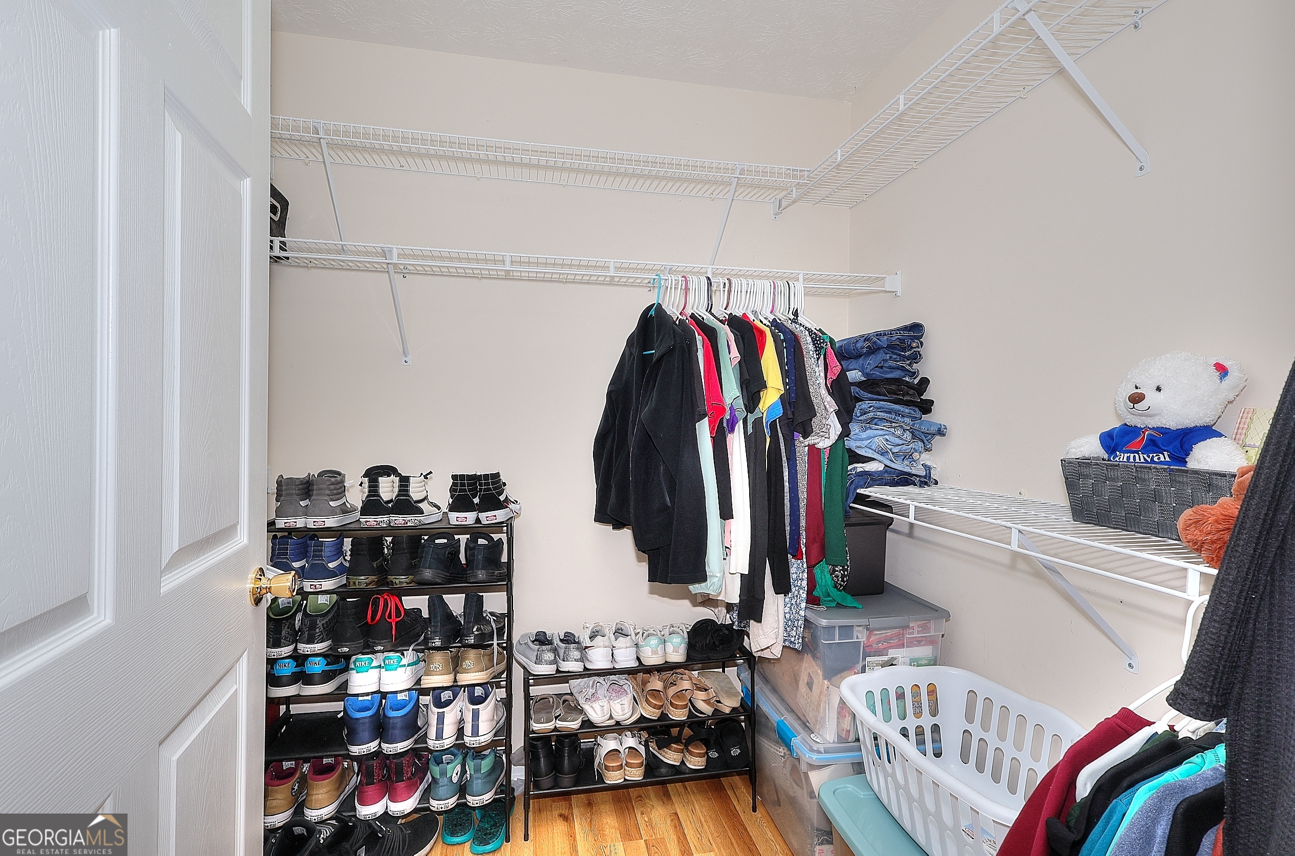 245 Tamea Trail Covington, GA 30014 - Photo 15 of 31 a view of walk in closet with clothes and shoes