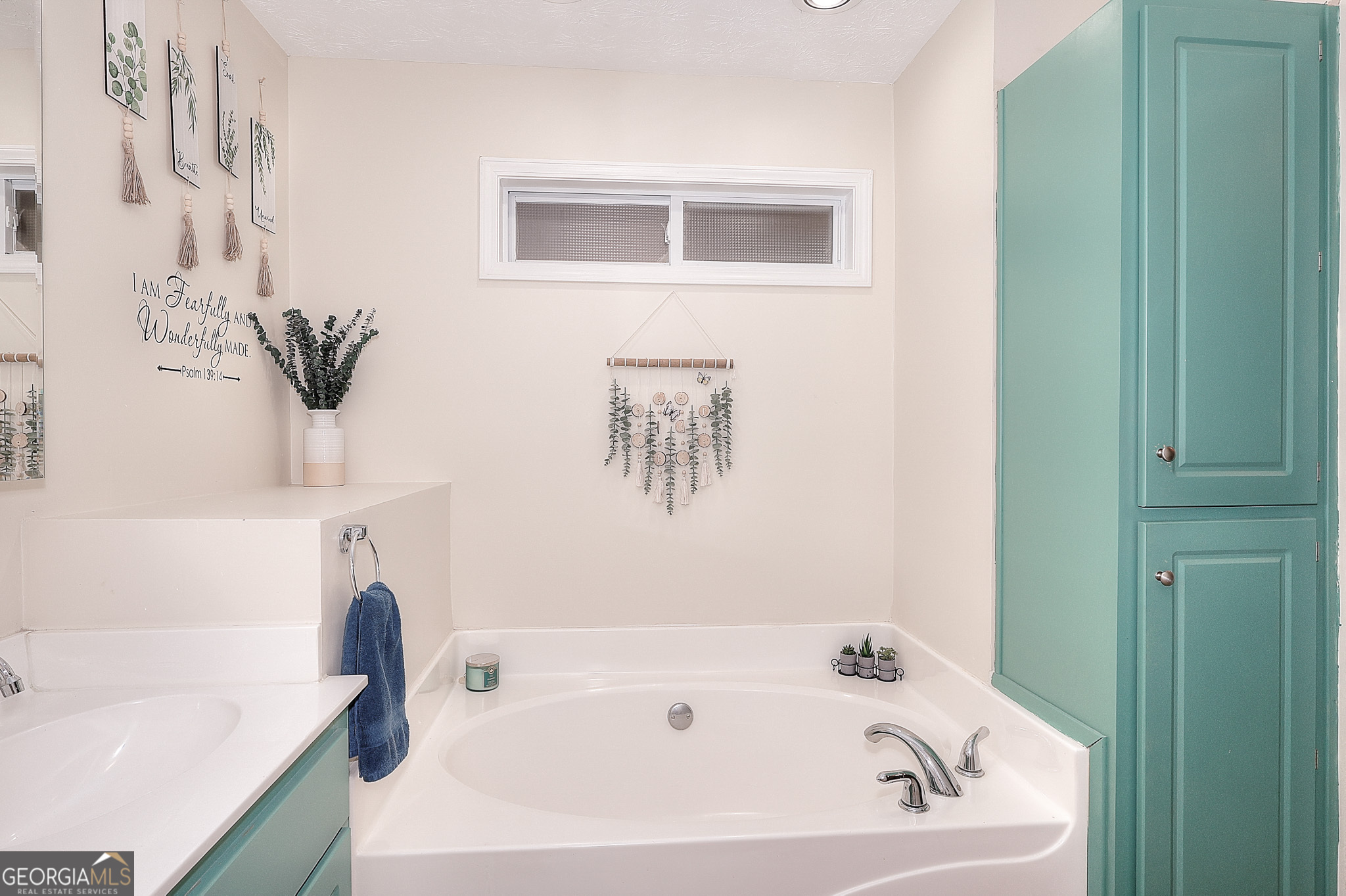 245 Tamea Trail Covington, GA 30014 - Photo 16 of 31 a bathroom with a bathtub and a sink