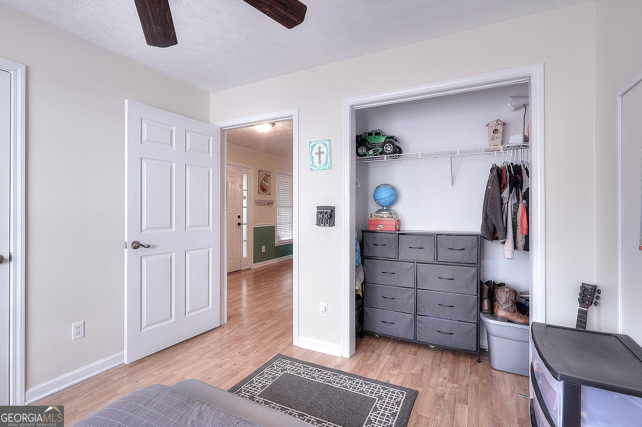 245 Tamea Trail Covington, GA 30014 - Photo 23 of 31 a view of walk in closet with clothes and shoes
