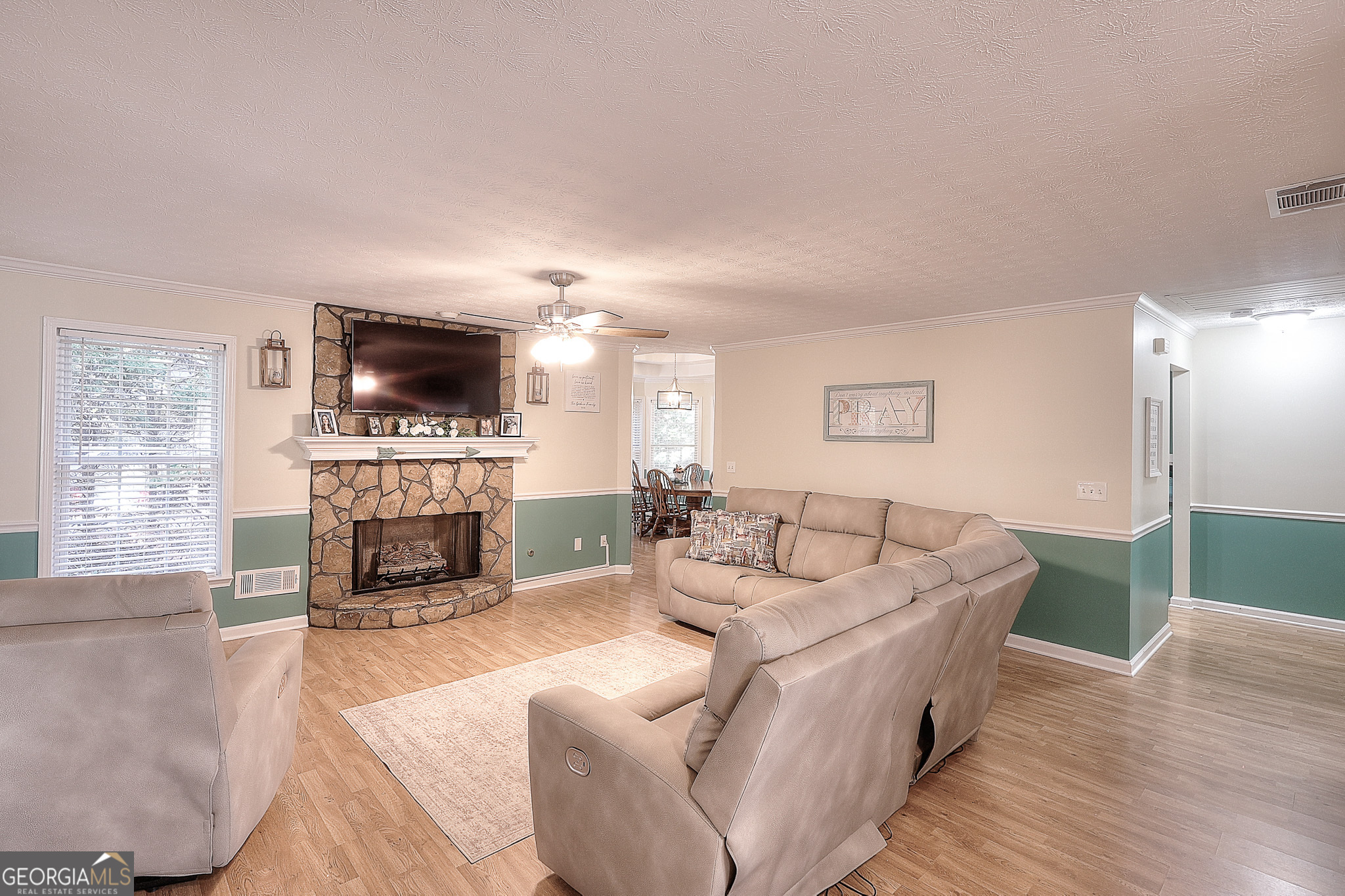245 Tamea Trail Covington, GA 30014 - Photo 3 of 31 a living room with furniture a fireplace and a flat screen tv