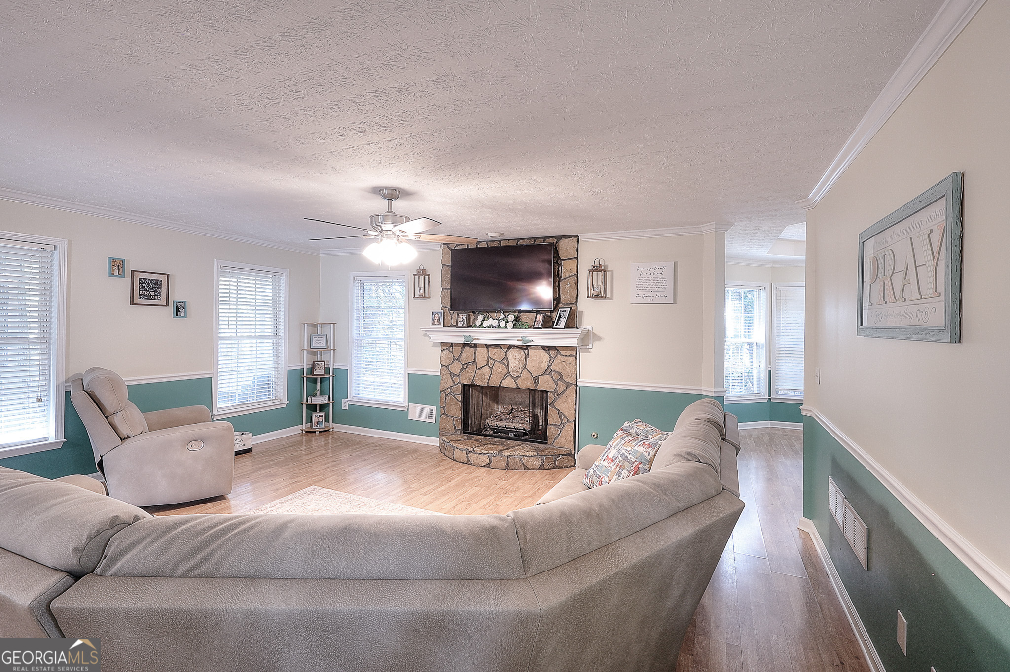 245 Tamea Trail Covington, GA 30014 - Photo 4 of 31 a living room with furniture a fireplace and a flat screen tv