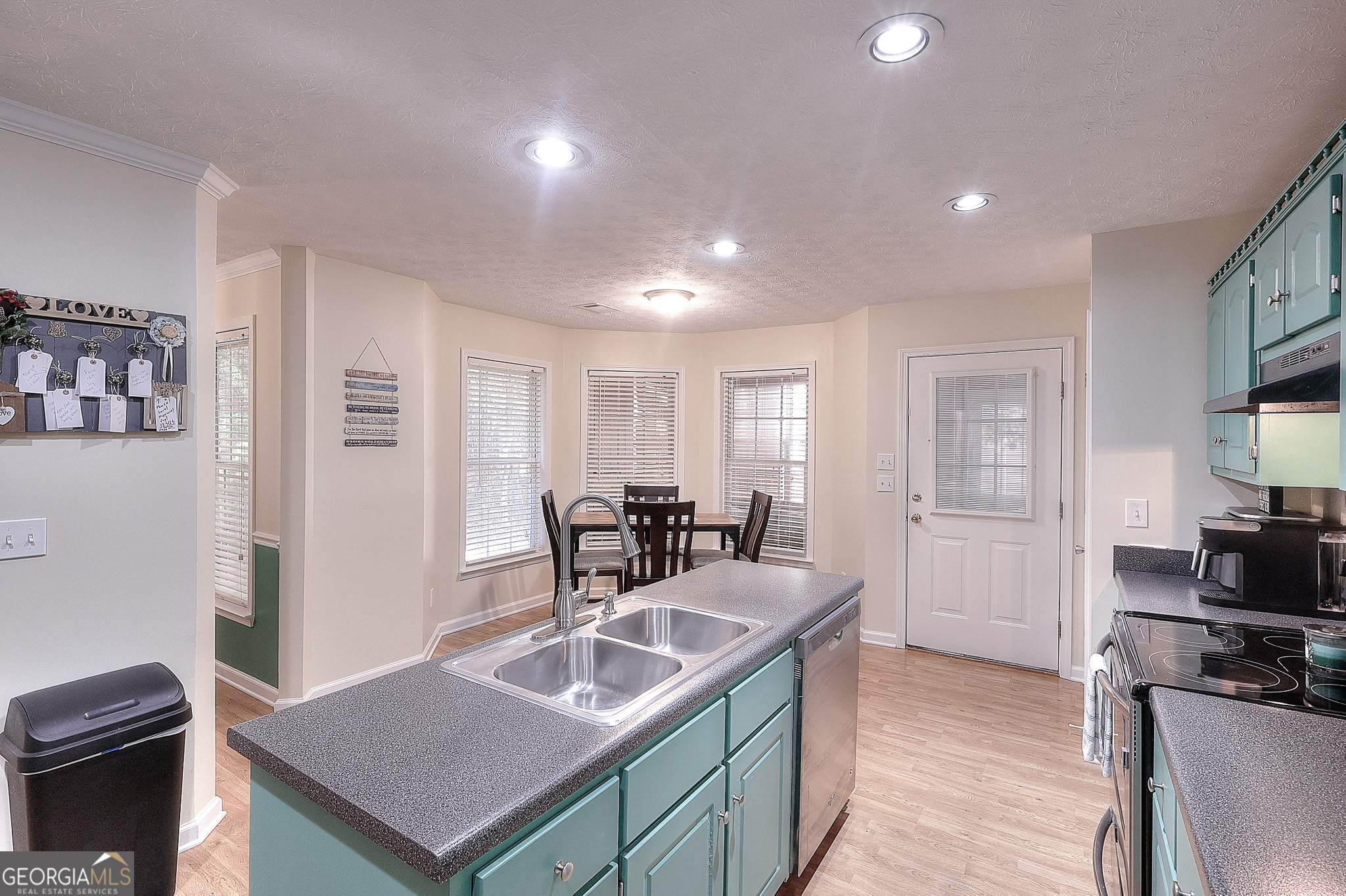 245 Tamea Trail Covington, GA 30014 - Photo 7 of 31 a kitchen with sink and refrigerator