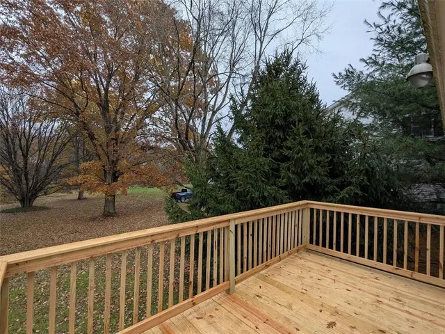 a view of wooden deck and trees