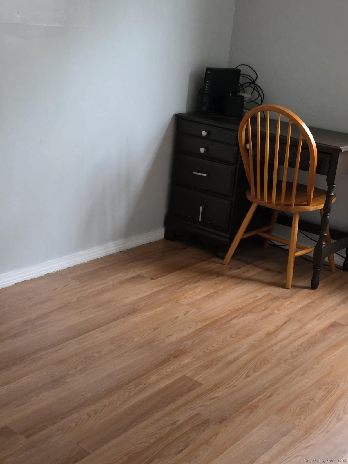 20 Lakeside Drive, Unit P Ledyard, CT 06339 - Photo 13 of 19 a room with wooden floor and black walls